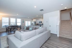 a living room with a white couch and a kitchen at Endless Summer Rental in Millville