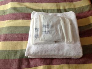 a white towel sitting on top of a bed at Pension Starlight Azumi in Hakuba +50 photos