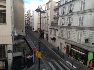 a city street with buildings and a street light at Hotel Marena in Paris