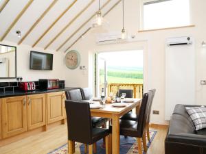 a kitchen and dining room with a table and chairs at Kentish Barn Retreat in Chilham