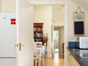 a kitchen with a table and a dining room at The Bothy At Fordcombe in Speldhurst