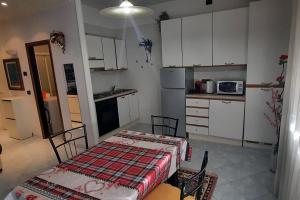 a kitchen with a table and chairs in a room at Zsuzsa Lak in Mestre