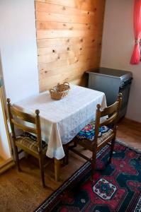 a table and two chairs with a basket on it at Apartment Aleksić in Žabljak