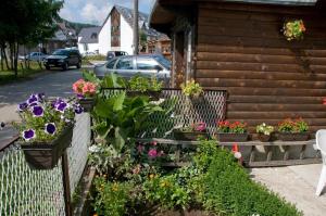 a garden of flowers on the side of a house at Apartment Aleksić in Žabljak