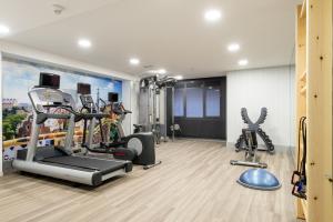 a gym with a treadmill and exercise equipment at Catalonia Park Putxet in Barcelona