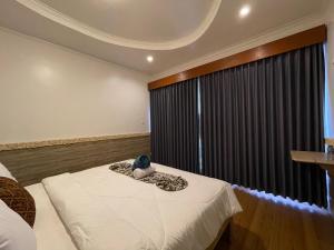 a bedroom with a bed and a large window at Mikuk Cottages Canggu in Canggu
