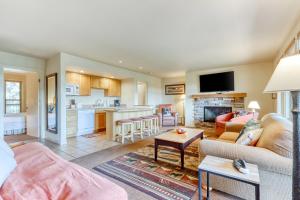 a living room with a couch and a table at Tree Top Retreat in Bend