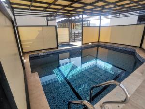 a swimming pool in a building at Highness Villa Nizwa in Nizwa