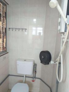 a bathroom with a toilet and a shower at Discovery Youth Hostel Malacca in Melaka