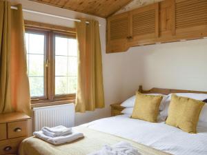 Otterford的住宿－Llama Lodge，一间卧室设有两张床和窗户。