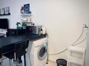 uma cozinha com uma máquina de lavar roupa e um balcão em Airport KLIA Guest House (1 bedroom & 1 toilet) em Sepang