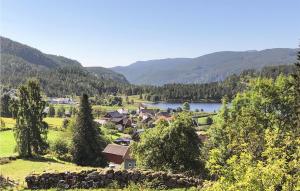a village with a lake and mountains in the background at 1 Bedroom Stunning Home In Tonstad in Tonstad