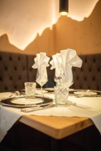 una mesa con vasos y servilletas encima en Hotel Villa Stefania, en San Candido