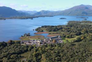 an aerial view of a castle on a island in a lake at The Lake Hotel in Killarney