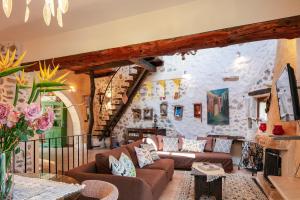 a living room with couches and a stone wall at Art Villa Kastellos in Kástellos