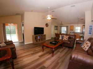 a living room with leather furniture and a flat screen tv at Great Community, Amazing Private Pool, Near Disney! in Davenport