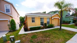 a house with a palm tree in a yard at Great Community, Amazing Private Pool, Near Disney! in Davenport