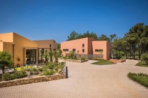 a house with a driveway in front of it at SOUND OF SEA Villas in Lixouri