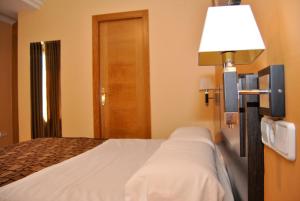 Postel nebo postele na pokoji v ubytování Hotel Reigosa