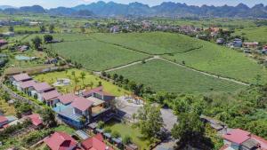 an aerial view of a resort with a large field at Emopea Moc Chau in Mộc Châu