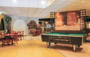 a room with a pool table in a restaurant at Vijverzicht 221 met whirlpool in Gramsbergen