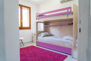 1 dormitorio con 2 literas y alfombra rosa en Valentina panoramic seaside house en Capitana