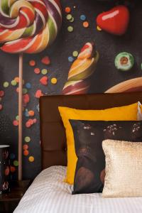 a bedroom with a bed with lollipops on the wall at The Chocolate Suites in Bruges