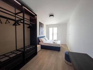 a bedroom with a bed and a room with a bunk bed at Bina Luxury Apartment in Cagliari