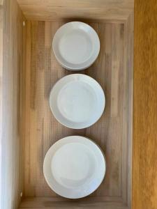 four white plates on a wall in a room at ゆったりとした時間を過ごせる一棟貸切の別荘　たけしま in Naruto