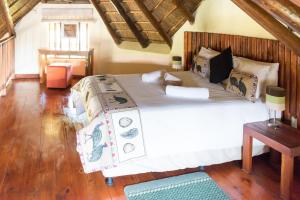 a bedroom with a large bed in a room at Impangele Lodge in Muldersdrift