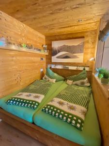 a bedroom with two beds in a wooden cabin at Damülser Holzhus in Damuls