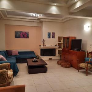 un soggiorno con divano e TV di Family Comfortable Spacious Apartment a Heraklion