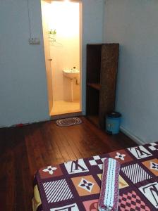 a room with a bathroom with a rug on the floor at Discovery Youth Hostel Malacca in Melaka