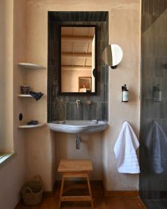 a bathroom with a sink and a mirror at Casa Mediterraneo Hotel in Meyisti