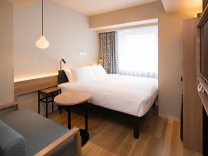 GRIDS PREMIUM HOTEL OTARU客房内的一张或多张床位
