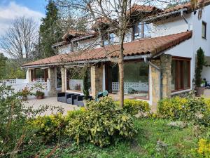 a large white house with a roof at Dreams and friends on the coast of Bilbao. in Getxo