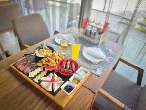 a table with a tray of food and drinks on it at Hotel City Code in Zenica