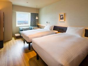 GRIDS PREMIUM HOTEL OTARU客房内的一张或多张床位
