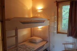 a bunk bed in a room with a window at Backs Semesterby in Duved