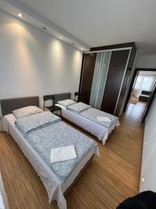 a room with three beds in it at Komfortowe mieszkanie dla 4 osób in Siedlce