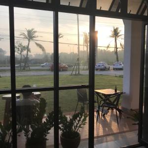 a person sitting at a table looking out of a window at The nearest Surattani airport in Surat Thani