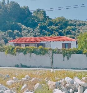 a white house with a red roof on the side of a road at Seaside Villa Eleni in Chorefto