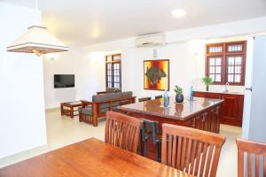 a kitchen and dining room with a table and chairs at Cinnamon Fence in Colombo