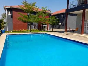 a swimming pool in front of a house at Top Lodge in Blantyre in Blantyre