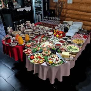 a table full of food and plates of food at Pensiunea Agroturistica Casa Brazilor 