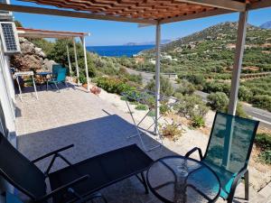 a patio with a view of the ocean from a house at Hari Apartments Vathi, Agios Nikolaos Crete in Vathi