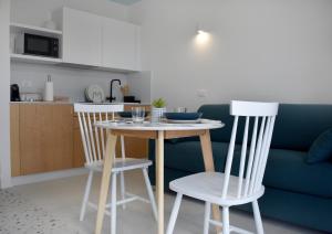 a table and two chairs in a living room at Il Grande Blu in Terracina