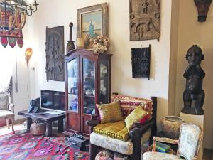 a living room with a chair and a cabinet at La Rosa del Deserto, Versilia in Marina di Massa