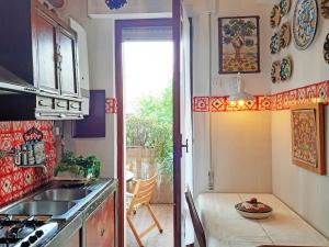 a kitchen with a sink and a stove top oven at La Rosa del Deserto, Versilia in Marina di Massa