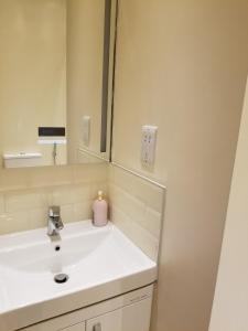 a bathroom with a sink and a mirror at London Luxury Studio Flat 4 min to Ilford Station with FREE parking FREE WiFi in Ilford